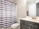 Upgraded bathroom featuring stylish fixtures, a vanity with storage, and a shower with purple accents at 753 Mountainwater Dr, Charlotte, NC 28262