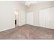 Spacious bedroom with plush carpeting, ceiling fan, multiple closets, and an ensuite bathroom entrance at 753 Mountainwater Dr, Charlotte, NC 28262