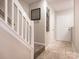 The entryway features a staircase, tile flooring, neutral paint, and stylish decor at 753 Mountainwater Dr, Charlotte, NC 28262