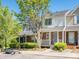 Exterior view of the townhouse with a brick facade and covered front porch at 753 Mountainwater Dr, Charlotte, NC 28262