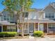 Charming townhome featuring brick accents, a cozy front porch, and manicured landscaping at 753 Mountainwater Dr, Charlotte, NC 28262
