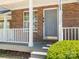 A inviting brick front porch and gray front door enhance the curb appeal at 753 Mountainwater Dr, Charlotte, NC 28262