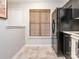 Kitchen features tile flooring, black appliances, neutral walls, and a window with a bamboo shade at 753 Mountainwater Dr, Charlotte, NC 28262