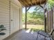 View of a covered patio with an entry door and natural backyard at 753 Mountainwater Dr, Charlotte, NC 28262