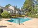 View of the community pool with mature landscaping and well-maintained perimeter at 753 Mountainwater Dr, Charlotte, NC 28262
