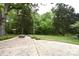 Enjoy a peaceful retreat in the expansive backyard with a firepit and mature trees at 8608 Cedarbrook Dr, Charlotte, NC 28215