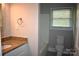 Bathroom vanity and toilet shown with granite countertop and tile floor at 8608 Cedarbrook Dr, Charlotte, NC 28215
