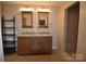Bathroom featuring double sinks, granite countertops, and a tiled shower at 8608 Cedarbrook Dr, Charlotte, NC 28215