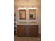 Bathroom vanity with granite countertops, double sinks, framed mirrors, and contemporary lighting at 8608 Cedarbrook Dr, Charlotte, NC 28215