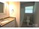 Bathroom featuring tile floors, a sink with a granite countertop, a toilet, and a bathtub with tiled wall at 8608 Cedarbrook Dr, Charlotte, NC 28215