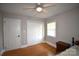 Bright bedroom with hardwood floors, a ceiling fan, and a closet at 8608 Cedarbrook Dr, Charlotte, NC 28215