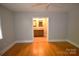 Bedroom with hardwood floors and ensuite bathroom entrance at 8608 Cedarbrook Dr, Charlotte, NC 28215