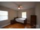 Cozy bedroom featuring hardwood floors, a ceiling fan, and natural light at 8608 Cedarbrook Dr, Charlotte, NC 28215