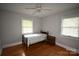 Bedroom featuring hardwood floors, ceiling fan, and natural light from two windows at 8608 Cedarbrook Dr, Charlotte, NC 28215