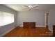A bedroom featuring hardwood floors, a ceiling fan, and a neutral color scheme at 8608 Cedarbrook Dr, Charlotte, NC 28215