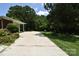 Long concrete driveway surrounded by mature landscaping leading to the home at 8608 Cedarbrook Dr, Charlotte, NC 28215