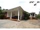 Covered rear carport and brick patio provides an inviting outdoor space for relaxing or entertaining in style at 8608 Cedarbrook Dr, Charlotte, NC 28215