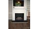 Living room with brick fireplace and mantel featuring tv at 8608 Cedarbrook Dr, Charlotte, NC 28215