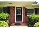 Close up of the front door with decorative glass and brick exterior detailing at 8608 Cedarbrook Dr, Charlotte, NC 28215