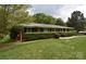 A charming ranch-style house with a well-kept lawn and a manicured privacy hedge at 8608 Cedarbrook Dr, Charlotte, NC 28215