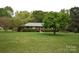 Classic brick ranch-style home with a well-maintained lawn and mature trees at 8608 Cedarbrook Dr, Charlotte, NC 28215