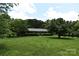 Charming home with a well-manicured front lawn and mature trees at 8608 Cedarbrook Dr, Charlotte, NC 28215