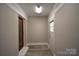 Hallway with vinyl flooring, neutral paint, and a window looking out to the outdoors at 8608 Cedarbrook Dr, Charlotte, NC 28215