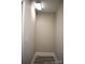 Neutral hallway with white trim and gray wood-look flooring is well-lit at 8608 Cedarbrook Dr, Charlotte, NC 28215