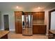 Kitchen view showcasing stainless steel refrigerator and wooden cabinets and granite countertops at 8608 Cedarbrook Dr, Charlotte, NC 28215