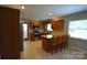 Open kitchen layout with wooden cabinets, granite countertops, stainless steel appliances, and island with seating at 8608 Cedarbrook Dr, Charlotte, NC 28215