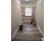 Bright laundry area features wood flooring, trim, natural light, and ample space for appliances and storage at 8608 Cedarbrook Dr, Charlotte, NC 28215