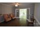 Living room view showing furniture and french doors to sunroom at 8608 Cedarbrook Dr, Charlotte, NC 28215
