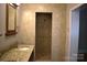 Walk-in shower with custom tile and unique design feature at 8608 Cedarbrook Dr, Charlotte, NC 28215