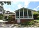 Bright sunroom addition with large windows offering natural light and views of the backyard at 8608 Cedarbrook Dr, Charlotte, NC 28215