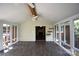 Bright sunroom with vaulted ceilings, wood floors, ample windows, and access to the interior at 8608 Cedarbrook Dr, Charlotte, NC 28215