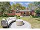 Landscaped backyard with patio seating and lush greenery, ideal for outdoor living and entertaining at 900 E Woodlawn Rd, Charlotte, NC 28209