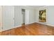 Bedroom features hardwood floors, neutral paint, white trim, window, and closet at 900 E Woodlawn Rd, Charlotte, NC 28209