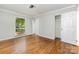 Bright bedroom featuring hardwood floors, a ceiling fan, and ample closet space at 900 E Woodlawn Rd, Charlotte, NC 28209