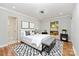 Bedroom features a modern ceiling fan, natural light, and hardwood floors at 900 E Woodlawn Rd, Charlotte, NC 28209