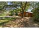 Charming brick home with a lush front yard shaded by a mature tree at 900 E Woodlawn Rd, Charlotte, NC 28209