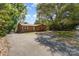 Charming brick home featuring a well-maintained front yard and a paved driveway, offering curb appeal at 900 E Woodlawn Rd, Charlotte, NC 28209
