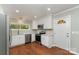 Well-lit kitchen with stainless steel appliances, granite countertops, and backyard view at 900 E Woodlawn Rd, Charlotte, NC 28209