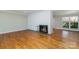 Inviting living room with hardwood floors, white brick fireplace, and large windows at 900 E Woodlawn Rd, Charlotte, NC 28209