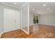 Bright living room featuring hardwood floors, fresh paint and a large picture window at 900 E Woodlawn Rd, Charlotte, NC 28209