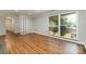 Living room featuring hardwood floors, large window, and neutral wall color at 900 E Woodlawn Rd, Charlotte, NC 28209