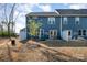 Backyard features a blue home exterior with white fence, patio set, and young tree in a partially dormant yard at 9031 Odell Corners Nw Blvd, Concord, NC 28027