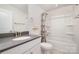 Bright bathroom featuring a shower-tub, white vanity, and gray countertop at 9031 Odell Corners Nw Blvd, Concord, NC 28027