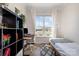 Bright bedroom setup with large window, desk, and stylish shelving and floor decor at 9031 Odell Corners Nw Blvd, Concord, NC 28027