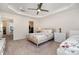 Well-lit bedroom with ceiling fan and walk-in closet, featuring two comfortable beds at 9031 Odell Corners Nw Blvd, Concord, NC 28027