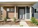 Inviting entryway featuring brick accents, a modern door, and manicured landscaping at 9031 Odell Corners Nw Blvd, Concord, NC 28027